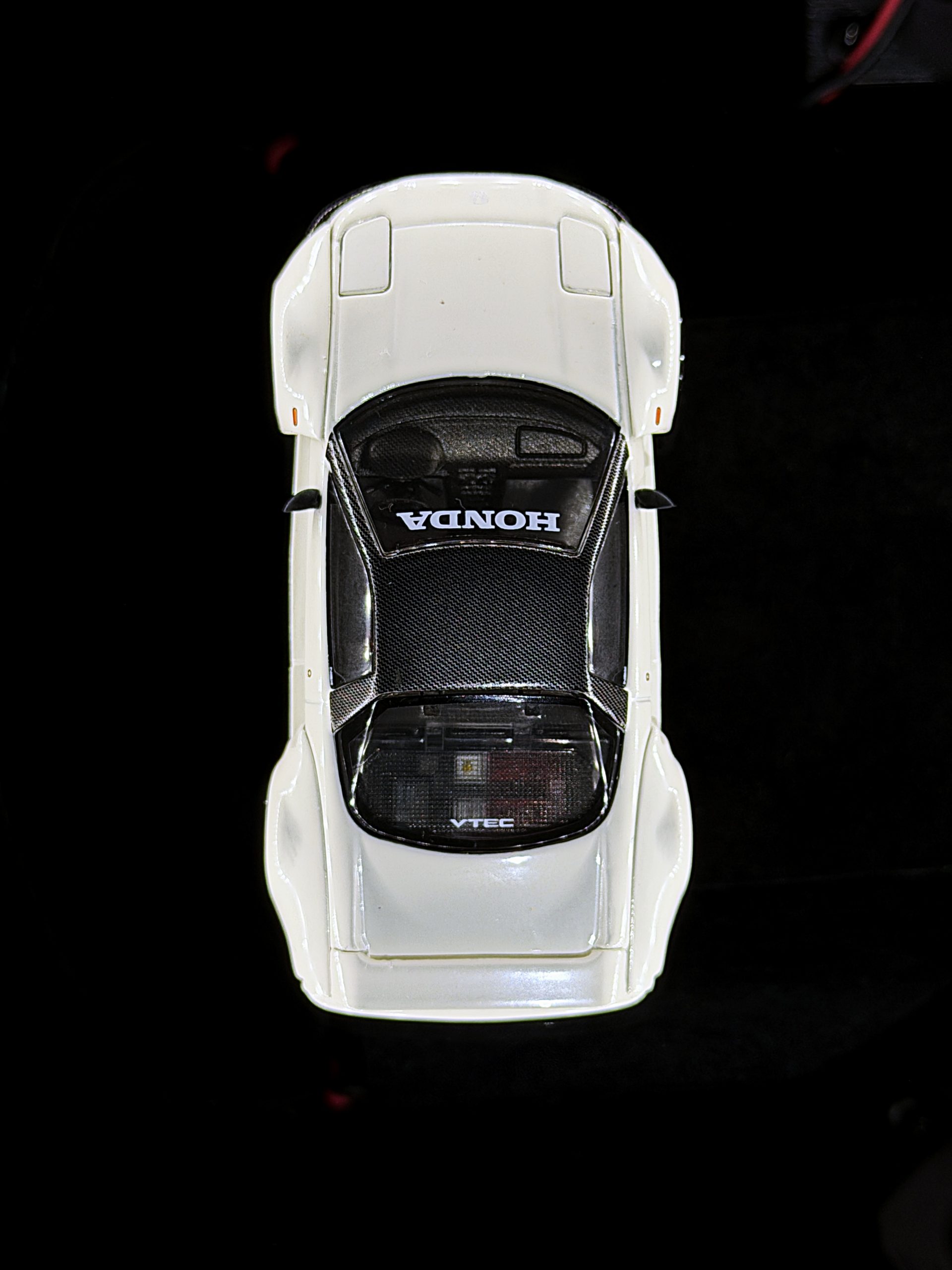 Top-down view of a white NSX model for diecast car photography with Halumin-C halo lighting