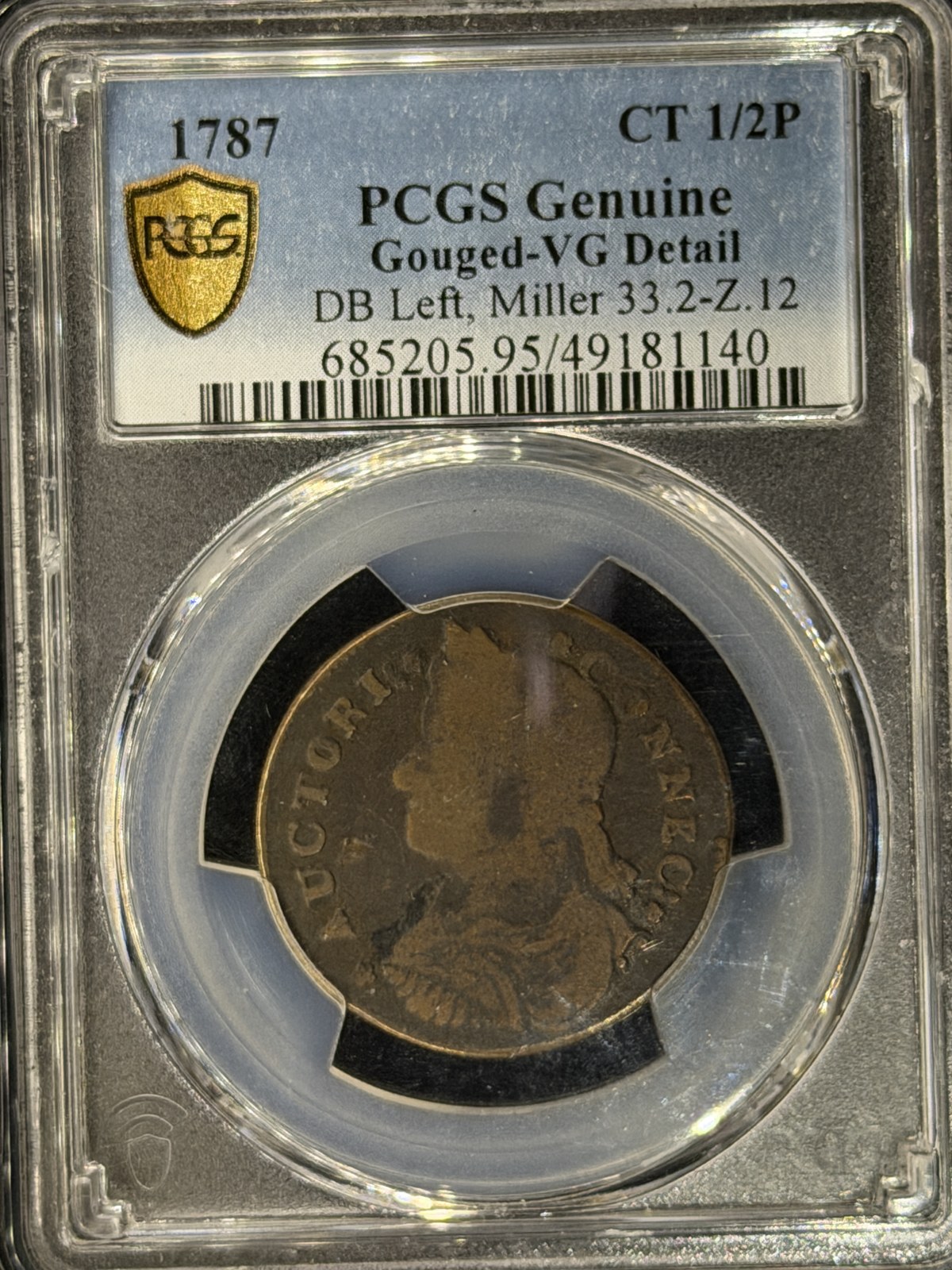 The same 1787 Connecticut copper in its PCGS slab under the Halumin-C tone light plus one side of the halo, with clear detail and patina