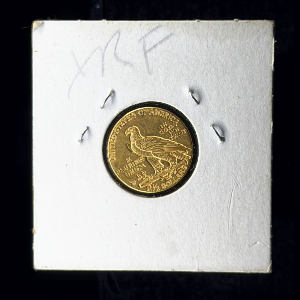 1915 Indian Head quarter eagle gold coin, reverse with the standing eagle, in a stapled cardboard 2x2 flip marked XRF, photographed in Halumin-C