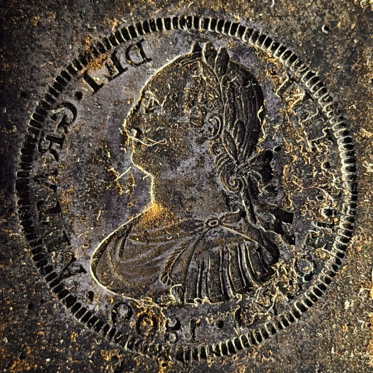 Coin die with a mirror-image portrait of King Charles IV (Carolus IIII), which its owner says struck 1800 Mexico 2 reales, photographed with Halumin-C and an iPhone