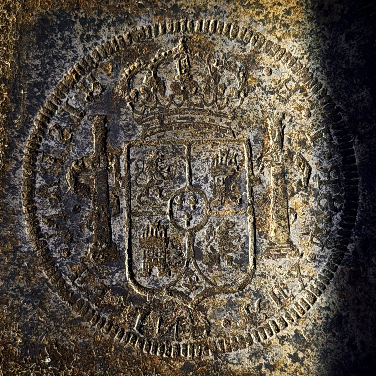 Coin die with the crowned Spanish shield and a pillar, which its owner says is the matching reverse, photographed with Halumin-C and an iPhone