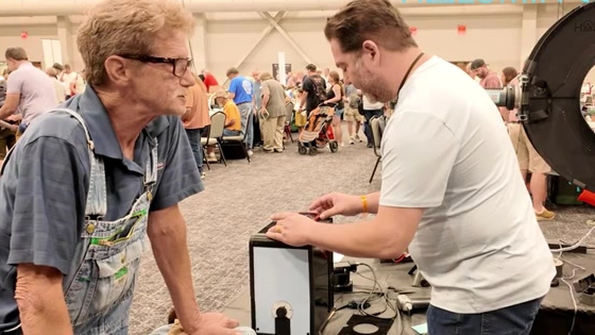 Photographing a coin die in the Halumin-C at the Cincinnati coin show while the die’s owner watches