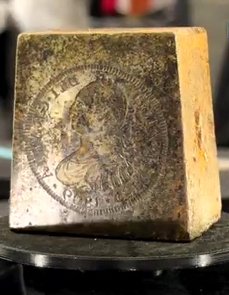 Heavy metal coin die rotating on the Halumin-C turntable, with the Carolus IIII portrait face visible