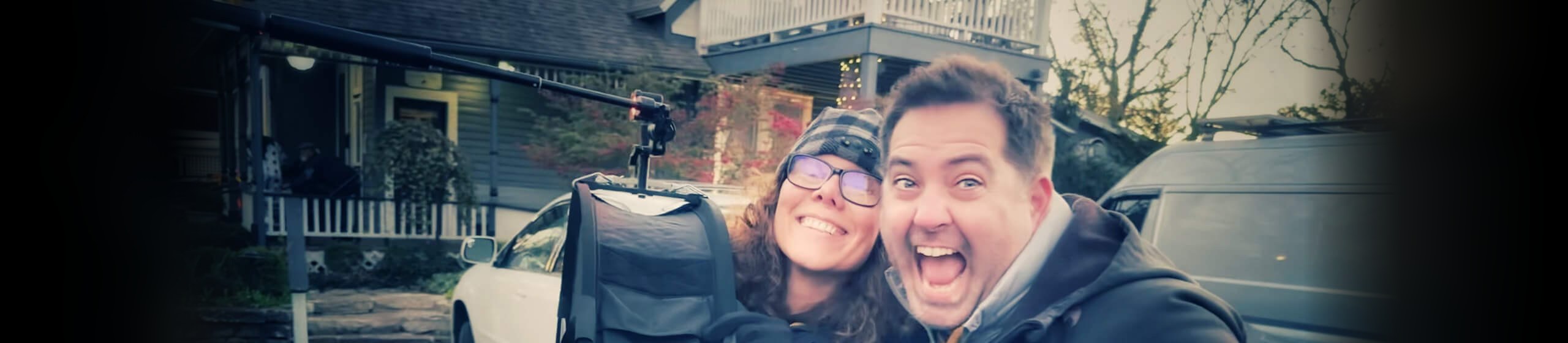 Halumin founder Jeremy Mason McGraw and his wife Suraya laughing together outdoors beside a Halumin lighting device on a stand