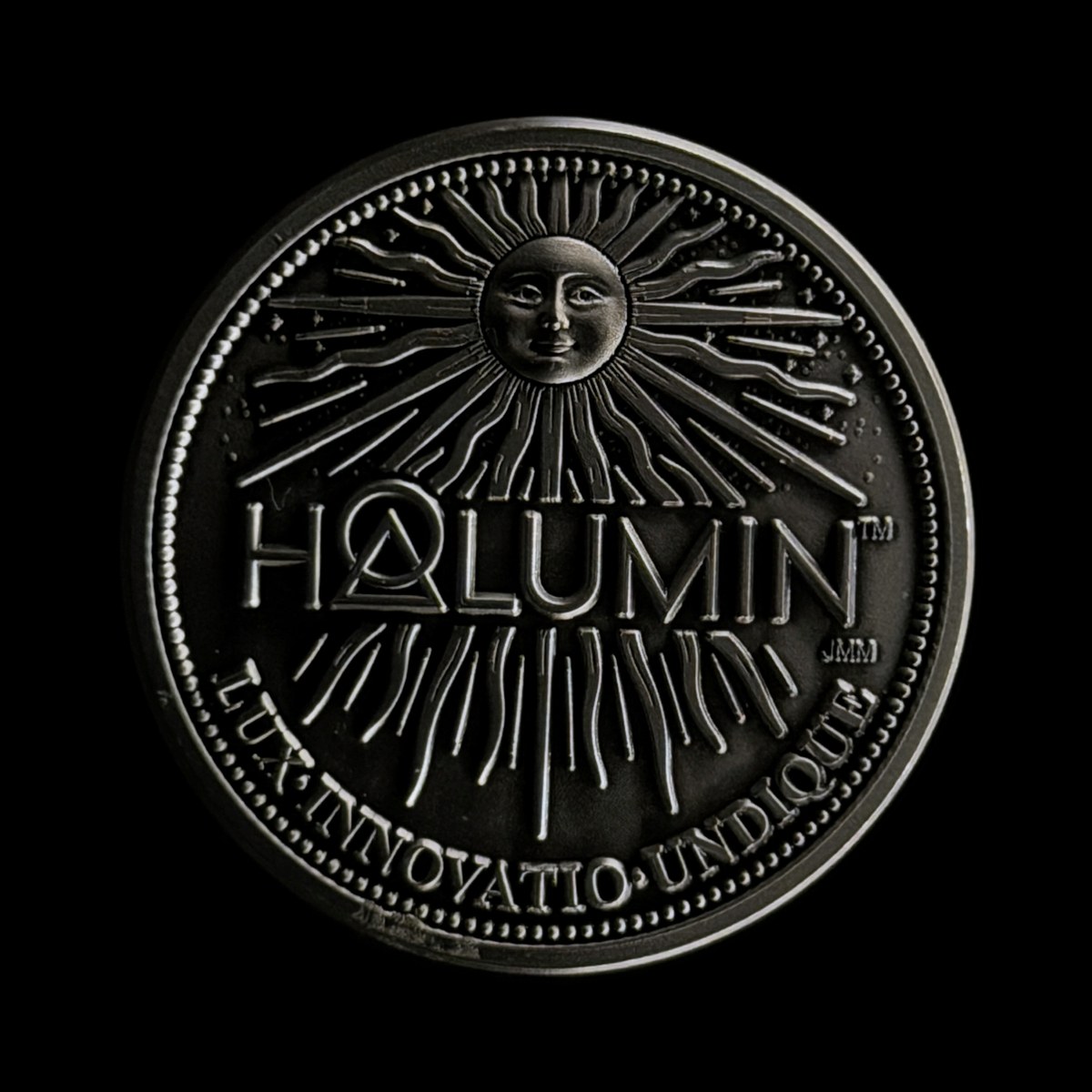 Sun face of the solid nickel Halumin coin under a different Halumin-C light mix, photographed with an iPhone