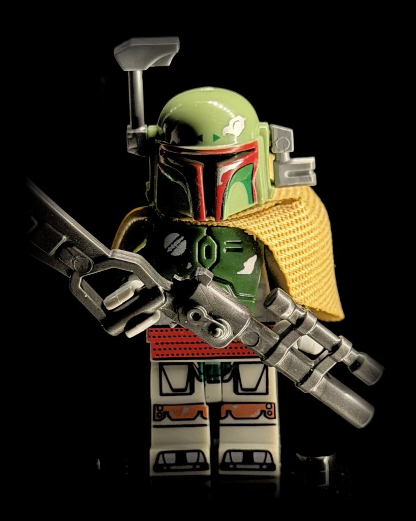 Boba Fett minifigure from a toy show with blaster and cape, lit by Halumin-C halo and axial lighting
