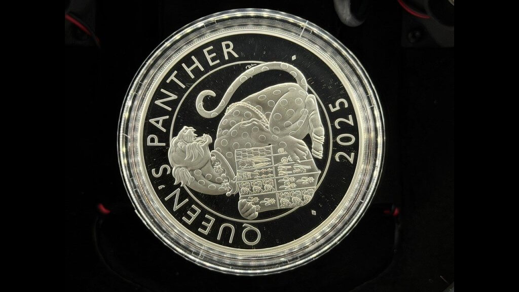 Silver proof coin with a black mirror-finish field and controlled reflections, photographed with the Halumin-C
