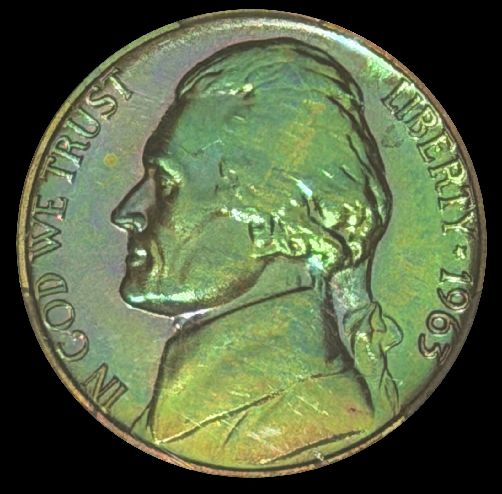 Toned 1963 Jefferson nickel with natural green, gold and violet toning photographed on black