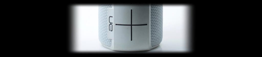 Close-up of a white UE Bluetooth speaker on a white background, lit with the Halumin H18 lighting device
