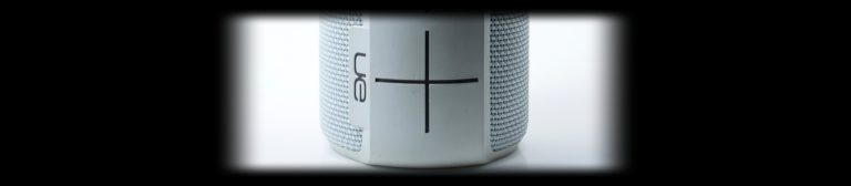 Close-up of a white UE Bluetooth speaker on a white background, lit with the Halumin H18 lighting device